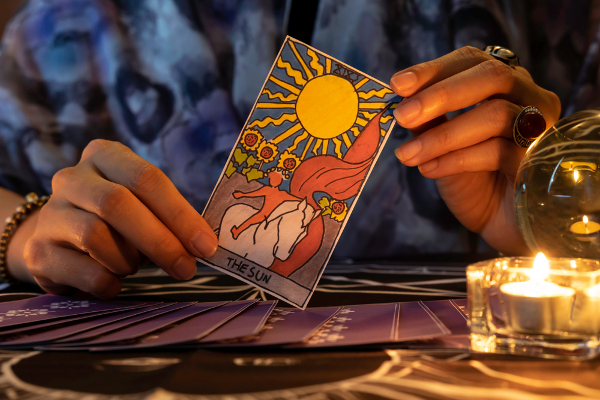 Image of Tarot Spread with Tarot card in hand